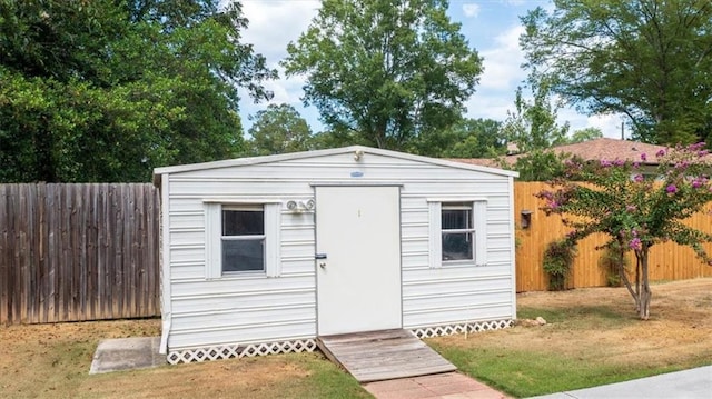 view of outbuilding with a lawn