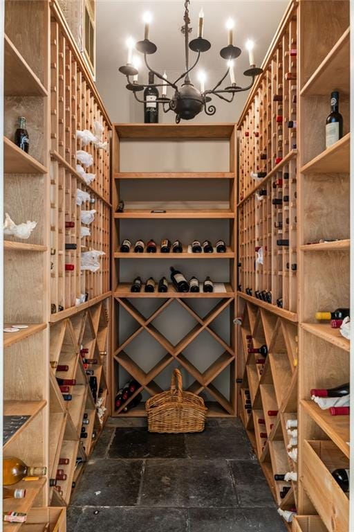 92 Old Ivy Rd NE Unit 6, Atlanta, GA 30342 - wine room featuring a chandelier and stone tile floors