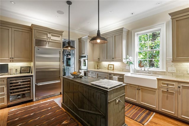 92 Old Ivy Rd NE Unit 6, Atlanta, GA 30342 - kitchen featuring stainless steel appliances, wine cooler, decorative backsplash, a center island, and ornamental molding