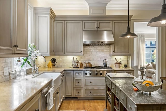 92 Old Ivy Rd NE Unit 6, Atlanta, GA 30342 - kitchen featuring exhaust hood, light stone counters, stainless steel gas stovetop, crown molding, and backsplash