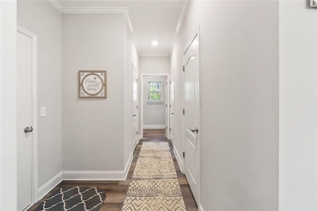 corridor featuring baseboards, crown molding, recessed lighting, and dark wood-style flooring