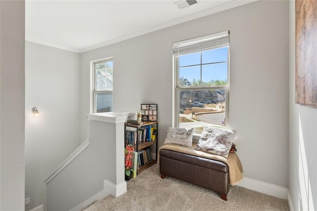sitting room with an upstairs landing, crown molding, baseboards, carpet floors, and visible vents