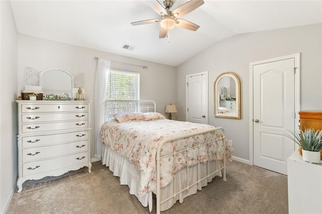 bedroom with ceiling fan, light carpet, vaulted ceiling, and visible vents