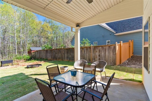 view of patio featuring outdoor dining space and fence