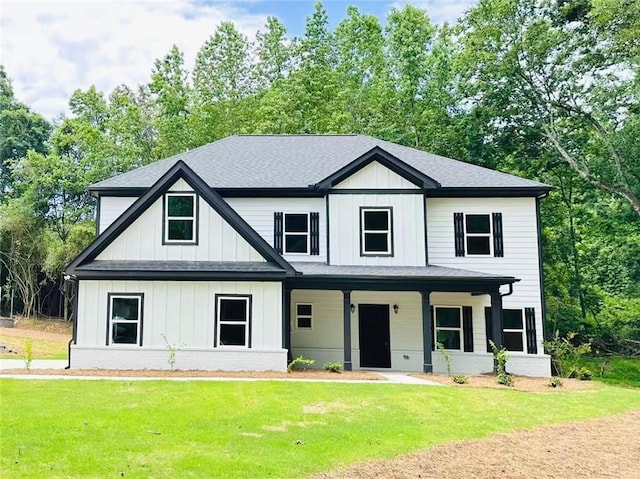 228 Hidden Ct, Winder, GA 30680 - modern farmhouse featuring a front yard, a shingled roof, covered porch, and board and batten siding
