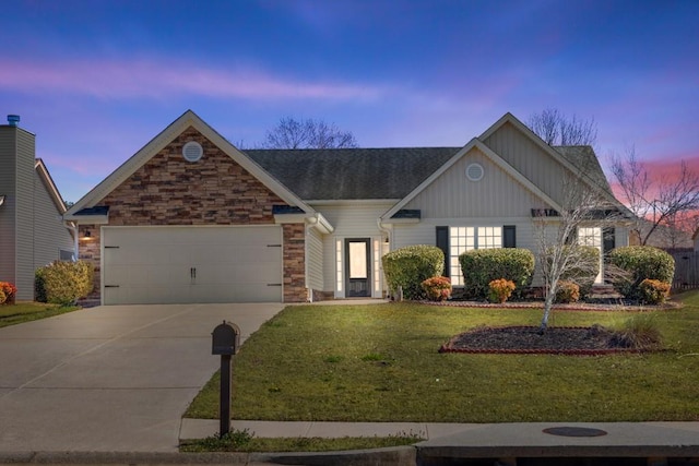 craftsman-style house with concrete driveway, a yard, an attached garage, and stone siding