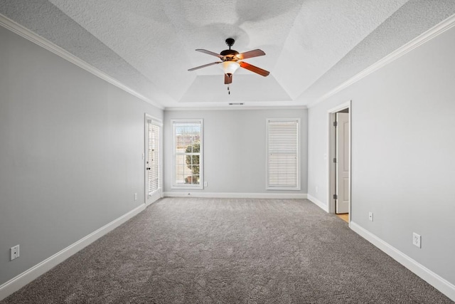 carpeted empty room with baseboards, a raised ceiling, a ceiling fan, ornamental molding, and a textured ceiling