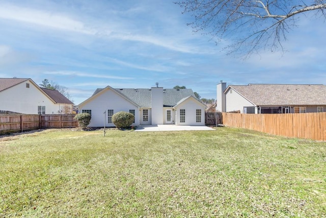 rear view of property featuring a patio area, a fenced backyard, and a lawn