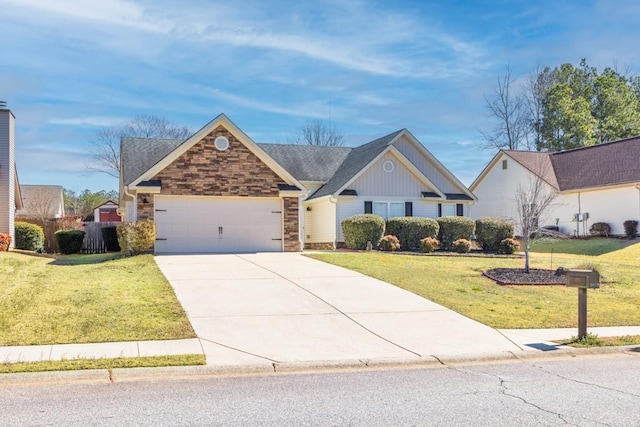 view of front of property with stone siding, a front yard, concrete driveway, and an attached garage