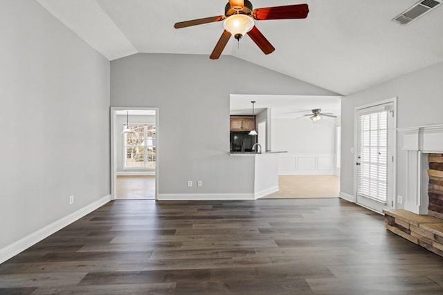 unfurnished living room featuring dark wood-style floors, lofted ceiling, visible vents, and a ceiling fan