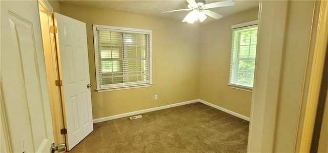 carpeted empty room with ceiling fan