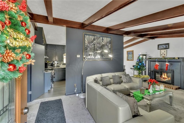 living room with light carpet and vaulted ceiling with beams