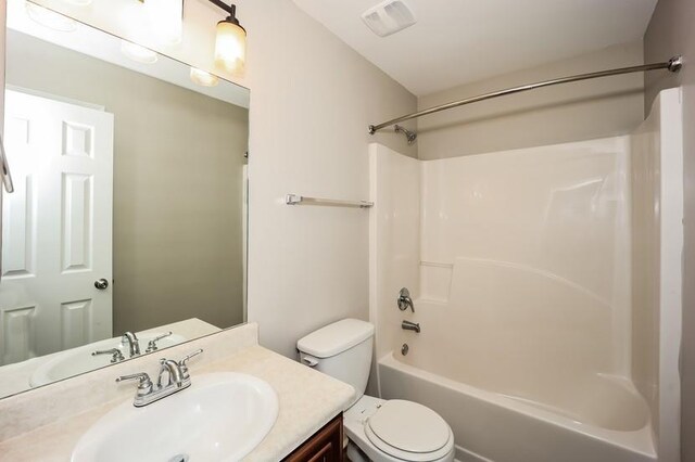 full bathroom with toilet, shower / tub combination, visible vents, and vanity