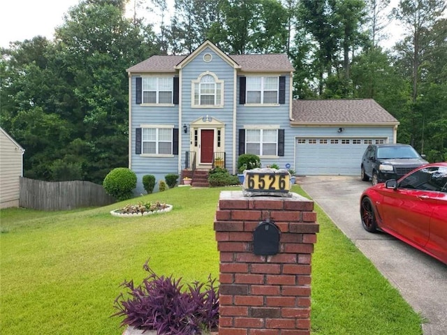 colonial-style house featuring a garage and a front yard