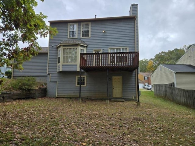 rear view of house featuring a lawn