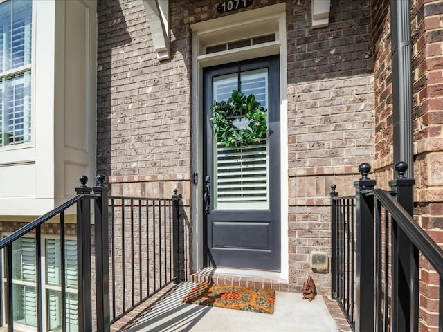 property entrance featuring brick siding