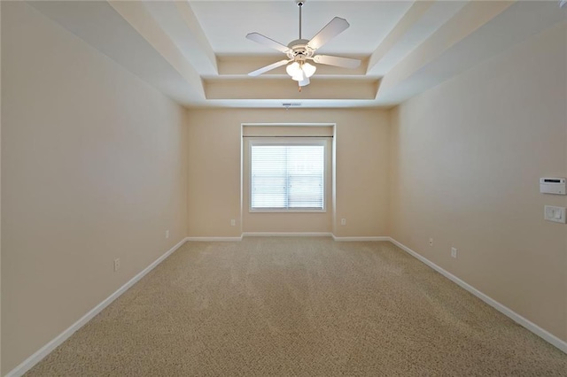 223 Glens Loop, Woodstock, GA 30188 - spare room with a raised ceiling, a ceiling fan, baseboards, and light carpet