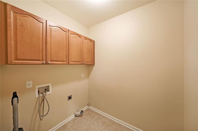 223 Glens Loop, Woodstock, GA 30188 - washroom featuring electric dryer hookup, hookup for a washing machine, cabinet space, baseboards, and light tile patterned flooring