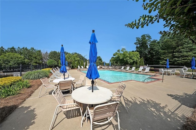 223 Glens Loop, Woodstock, GA 30188 - community pool with a patio area and view of wooded area
