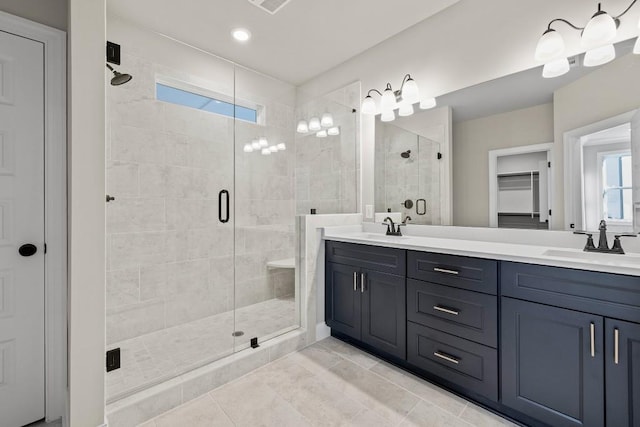 bathroom with tile patterned flooring, a shower with door, and vanity