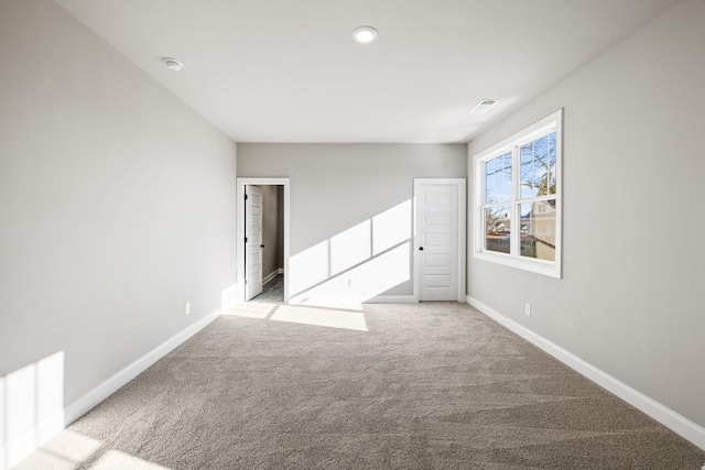 spare room with light colored carpet