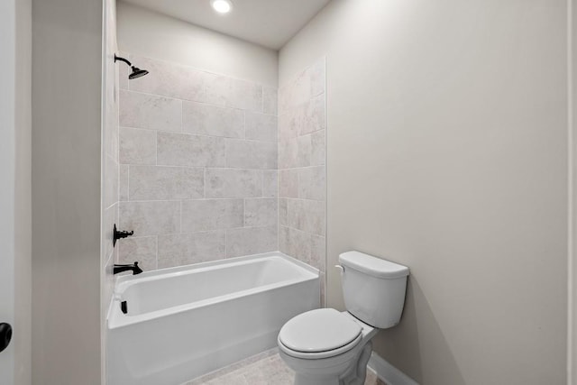 bathroom with toilet, tiled shower / bath combo, and tile patterned flooring