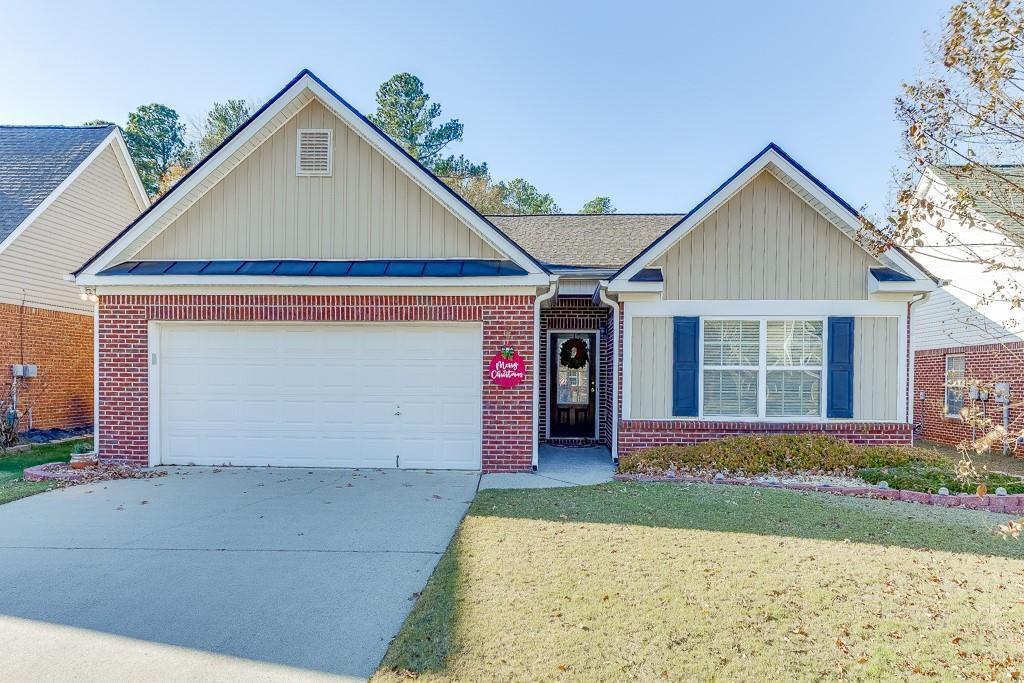 view of front of property with a front lawn and a garage