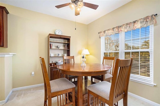 carpeted dining area featuring ceiling fan