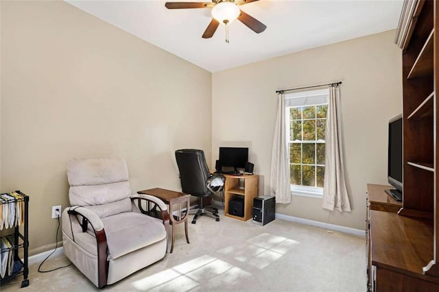 carpeted office space featuring ceiling fan