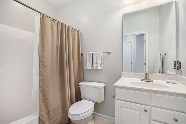 full bathroom with toilet, vanity, and shower / bath combo with shower curtain