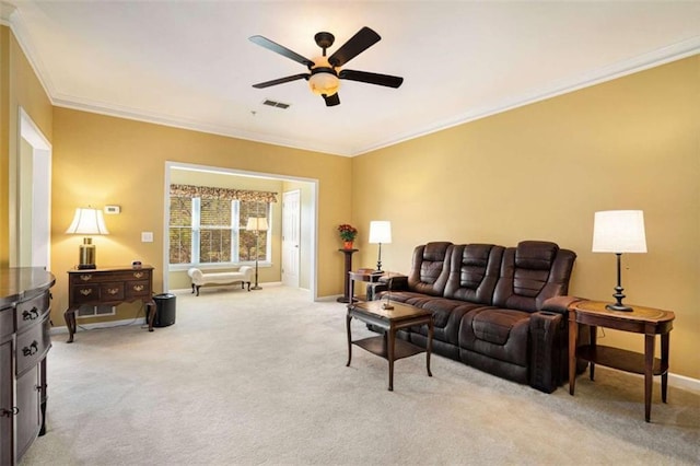 living room featuring ceiling fan, light colored carpet, and ornamental molding