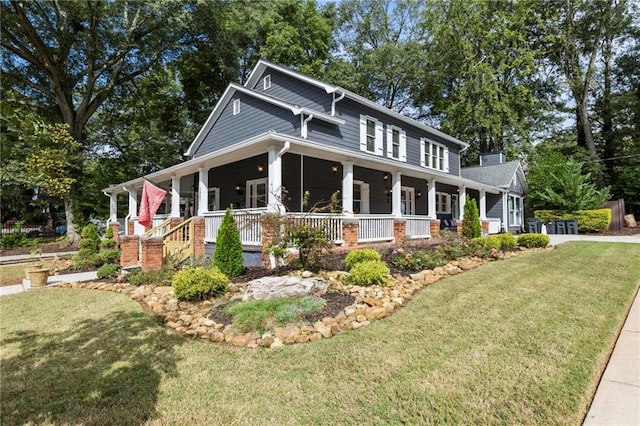 view of front of house with a porch and a front yard