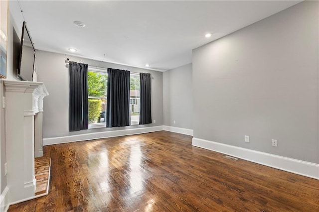 unfurnished living room featuring wood-type flooring