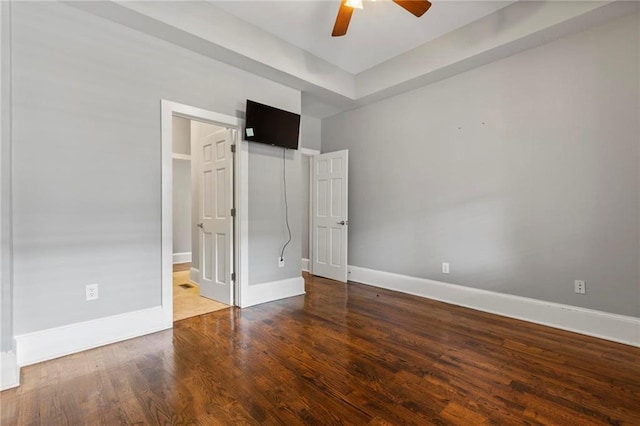 unfurnished bedroom featuring ensuite bath, ceiling fan, and hardwood / wood-style flooring