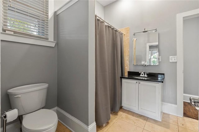 bathroom with vanity, toilet, and tile patterned floors