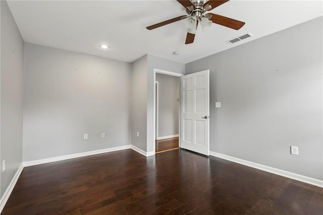 spare room with dark hardwood / wood-style floors and ceiling fan