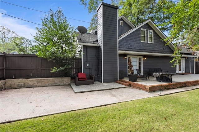 back of property with a patio and a lawn