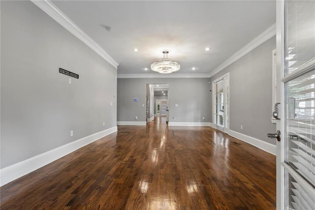 unfurnished living room with ornamental molding, dark hardwood / wood-style floors, a chandelier, and french doors