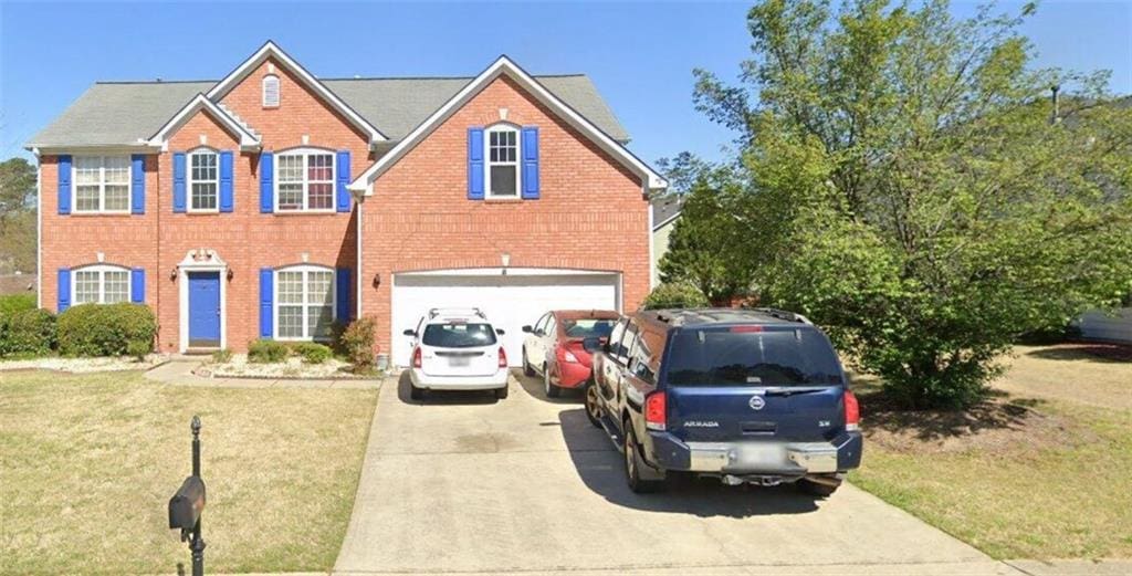 1685 Great Oaks Dr, Lawrenceville, GA 30045 - view of front facade featuring driveway, brick siding, and a garage