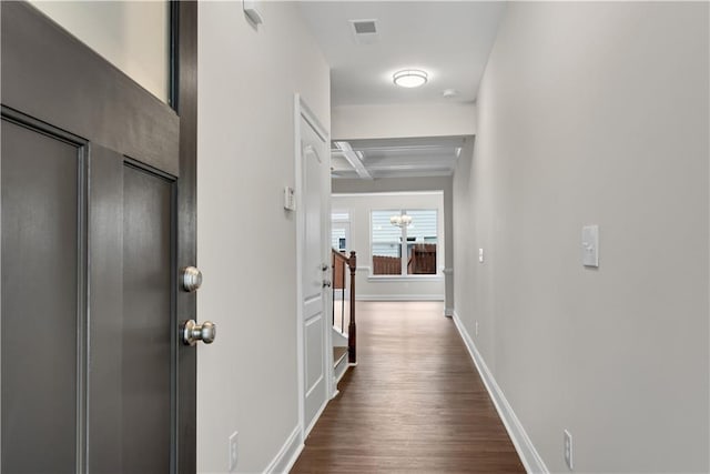 hallway featuring beamed ceiling, coffered ceiling, and dark hardwood / wood-style flooring