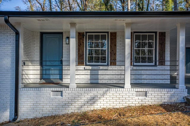 view of exterior entry with covered porch