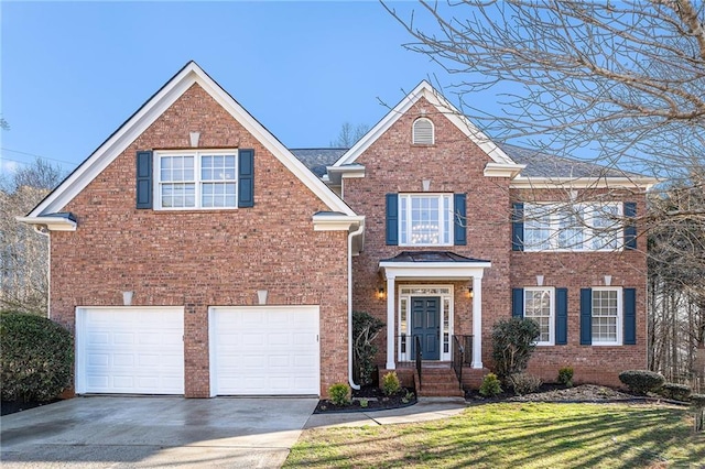 view of front of house with concrete driveway, a garage, brick siding, and a front yard