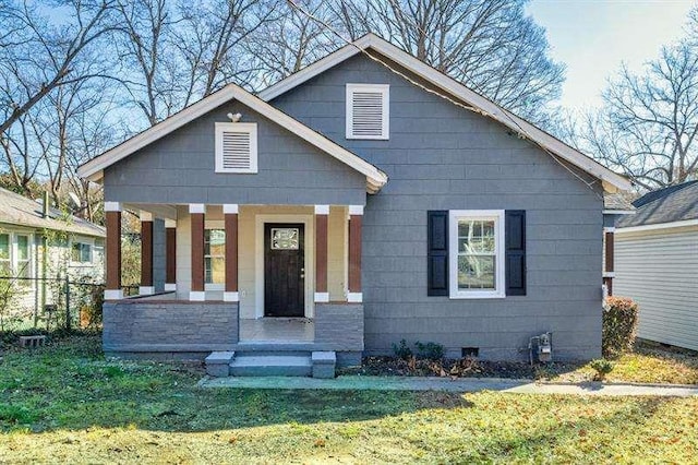 view of front of home featuring covered porch and a front yard