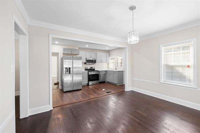 kitchen featuring decorative light fixtures, stainless steel appliances, a wealth of natural light, and sink