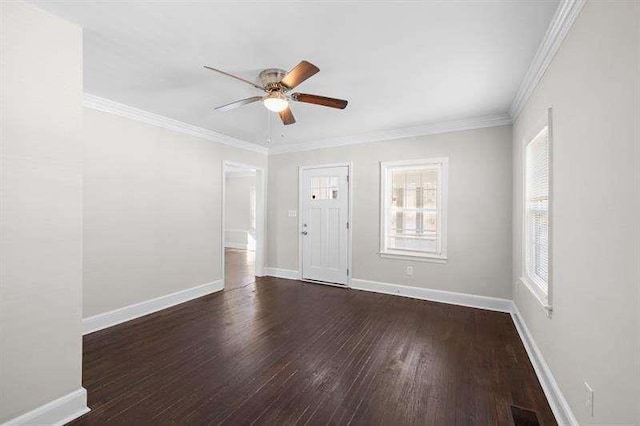 spare room with ceiling fan, dark hardwood / wood-style flooring, and crown molding