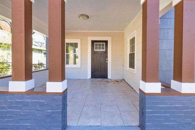 doorway to property featuring covered porch