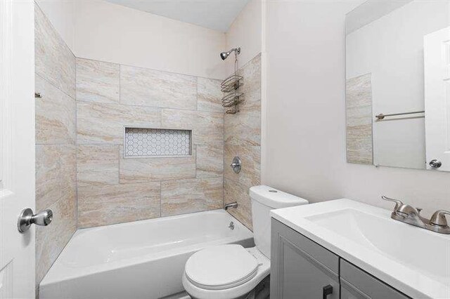 full bathroom with vanity, toilet, and tiled shower / bath