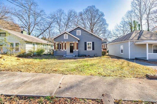 view of front of property with a porch and a front lawn