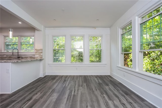 unfurnished sunroom with sink and a wealth of natural light