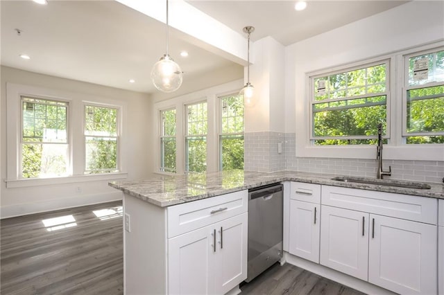 kitchen with dishwasher, sink, plenty of natural light, white cabinetry, and decorative light fixtures